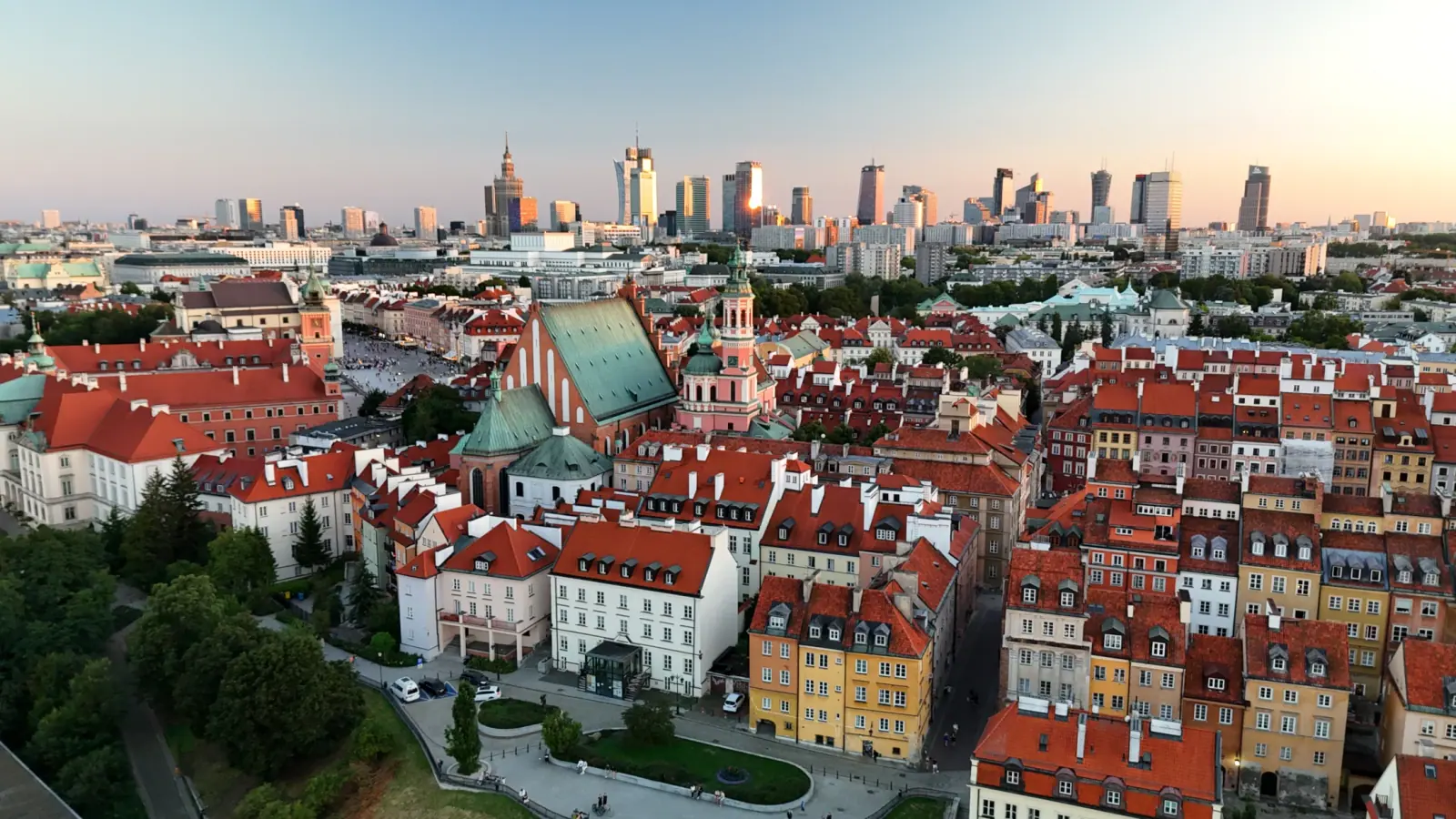 Terracotta rooftops of the Old Town with Warsaw business skyline behind