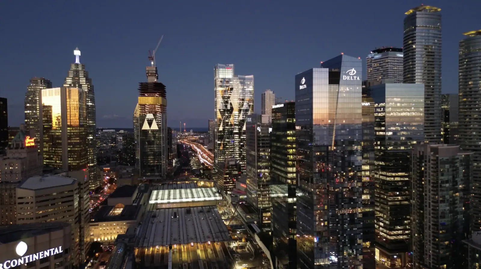 Downtown skyline at dusk with illuminated skyscrapers